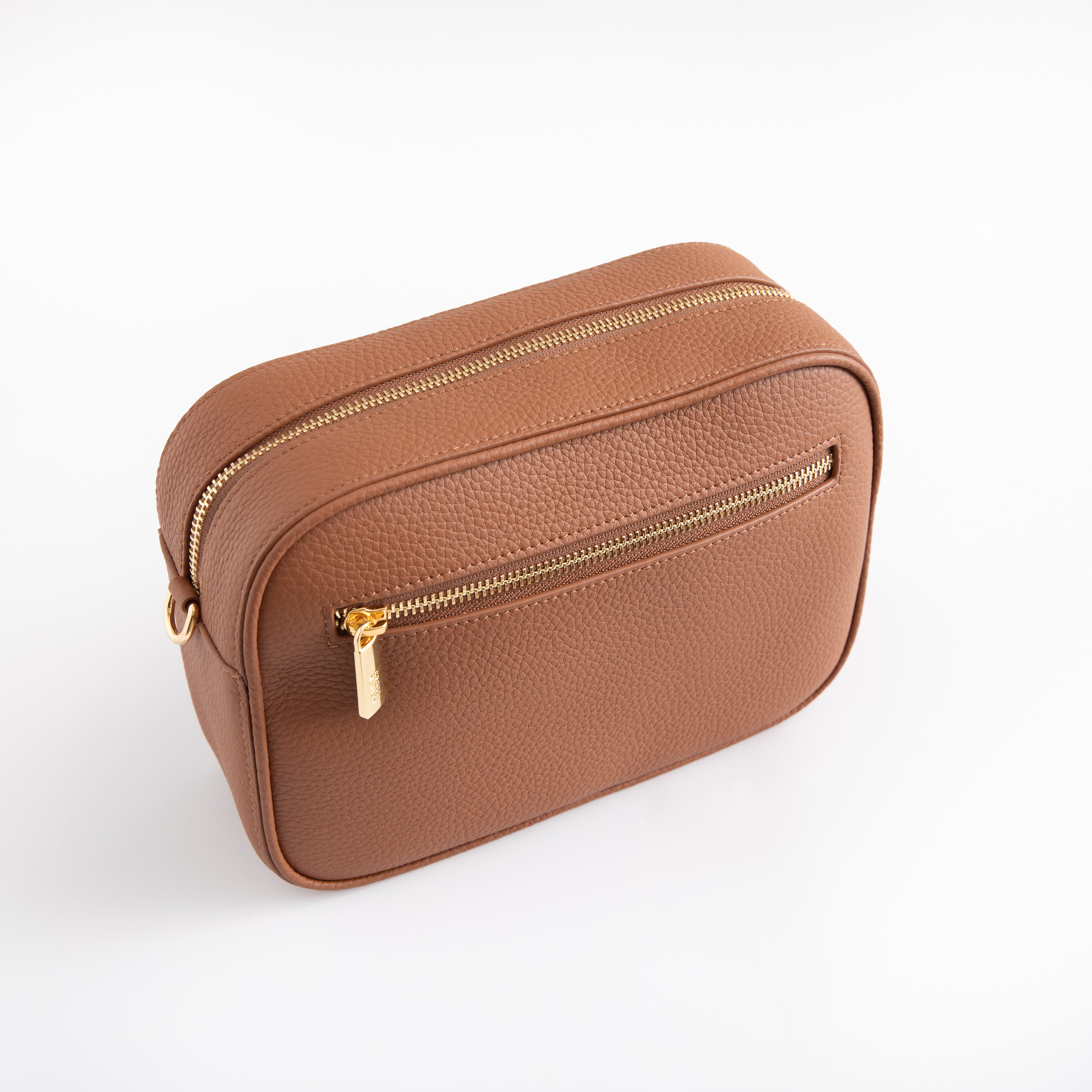 Brown leather bag with gold zipper on a white background