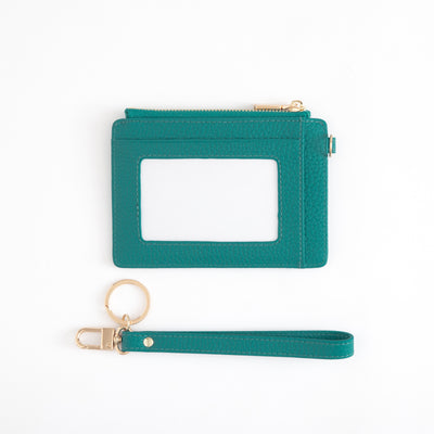 Teal cardholder with a matching wristlet on a white background