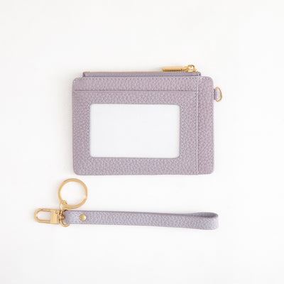 Light purple cardholder with gold keychain on a white background