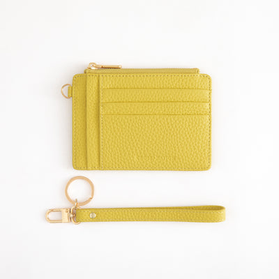 Yellow wallet with keychain on a white background