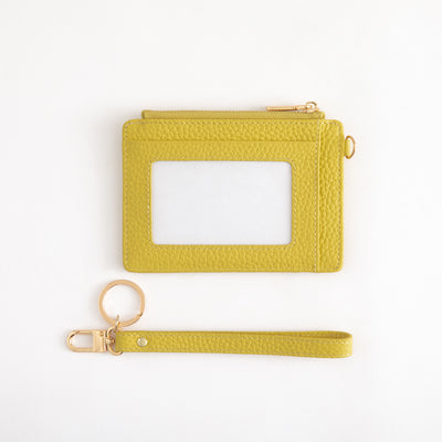 Yellow cardholder with keychain and wrist strap on a white background