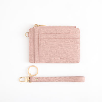 Pink wallet and keychain set on a white background