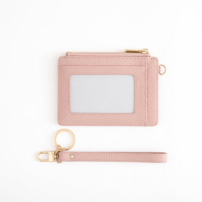 Pink cardholder with a keychain on a white background