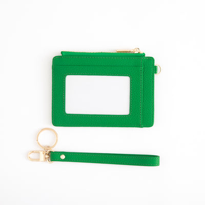 Green cardholder with a detachable strap on a white background