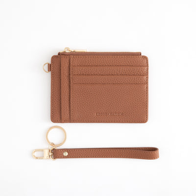 Brown leather wallet with keychain on a white background
