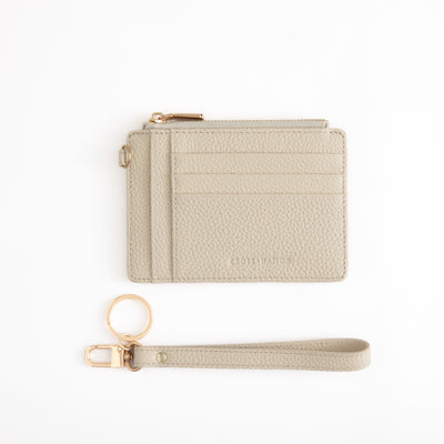 Beige cardholder with wrist strap on a white background